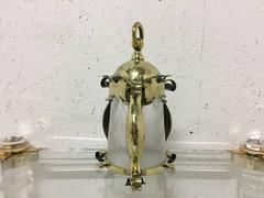 An Arts and Crafts Hammered Brass Lantern with Opaque Ribbed Glass Liner