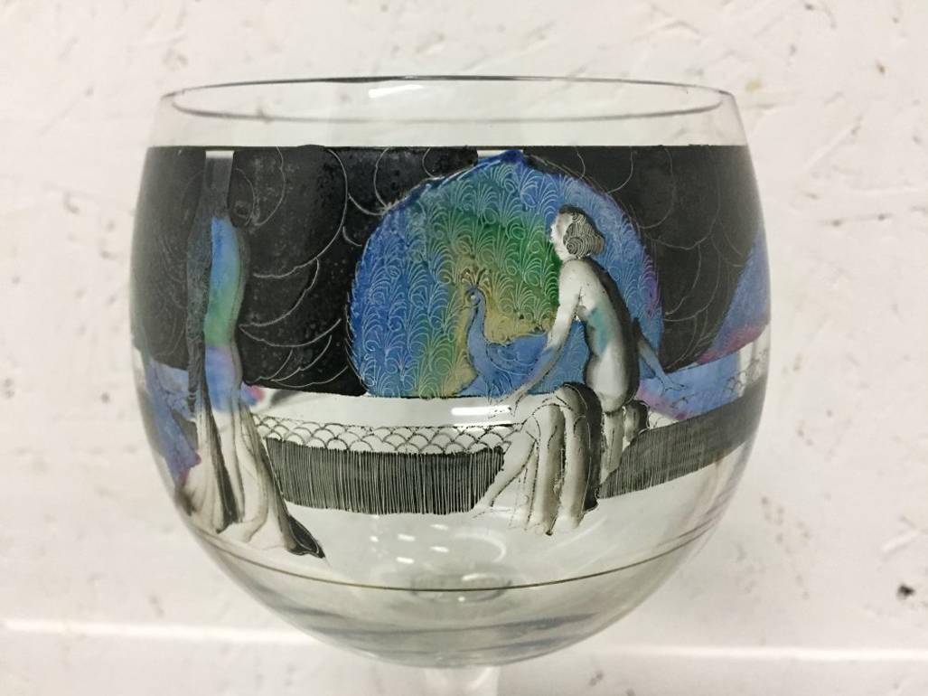 A wine glass with hand-painted enameling of a naked lady amongst peacocks, by Vetri Della Arte 'Vedar'.