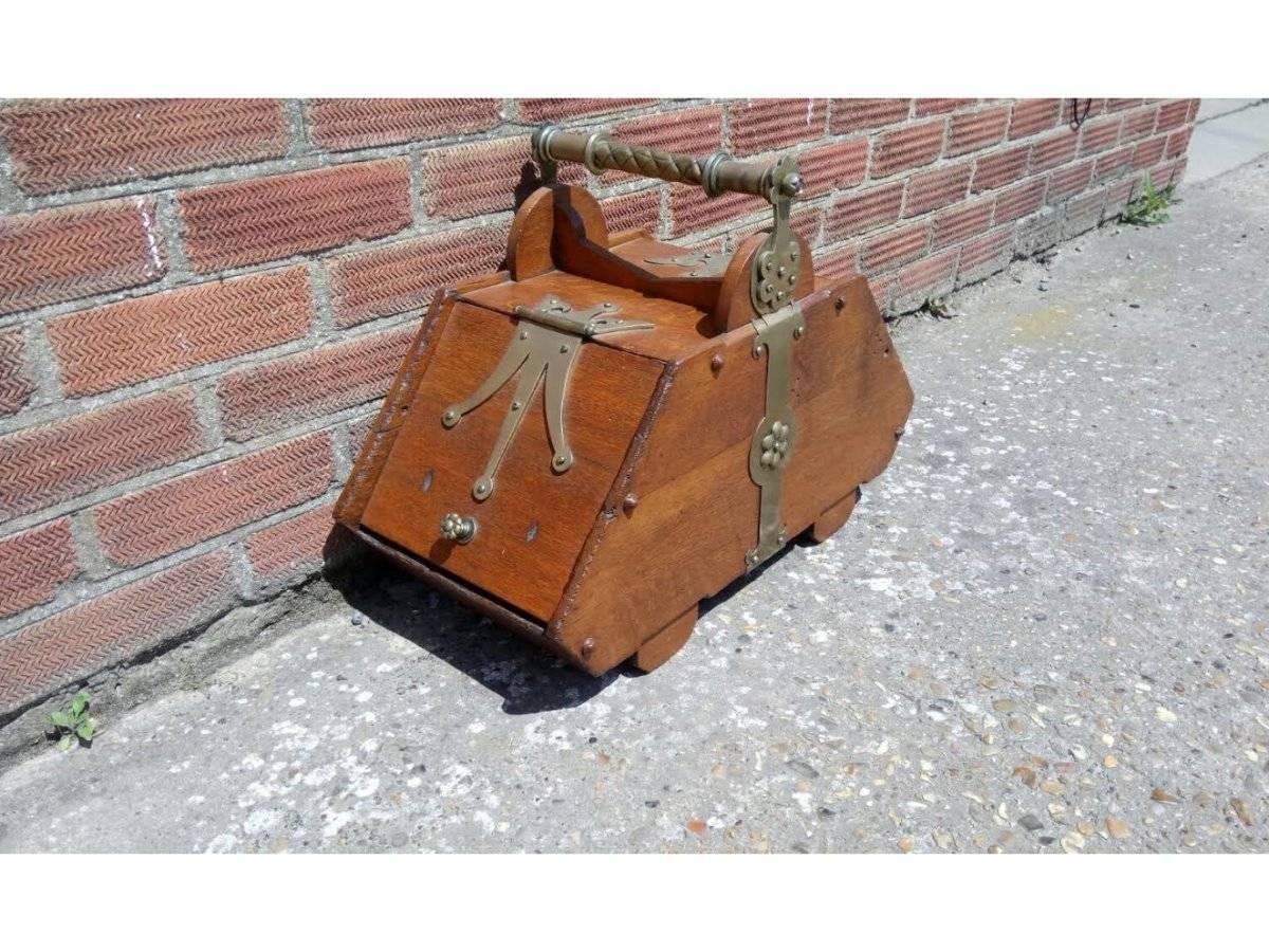  Dr C Dresser for Benham & Froud.  London.
A good Gothic Revival oak coal box with stylized brass strap hinges and a decorated brass handle.
Measures: Height 17 1/2