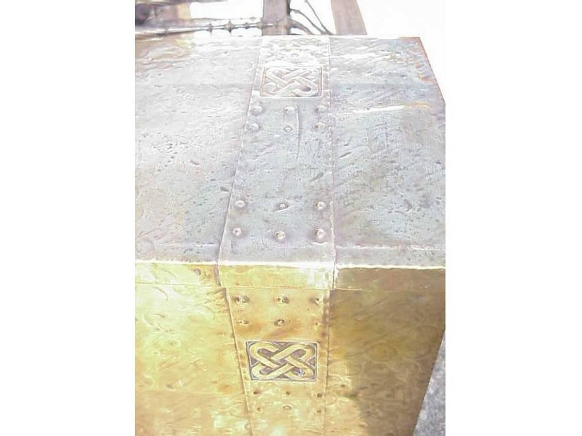 An Arts and Crafts Glasgow style brass coal box in the Margret Gilmour style with hand formed stylized Celtic details to the front and top with squashed ball feet.
Measures: Height 12", width 21", depth 14".