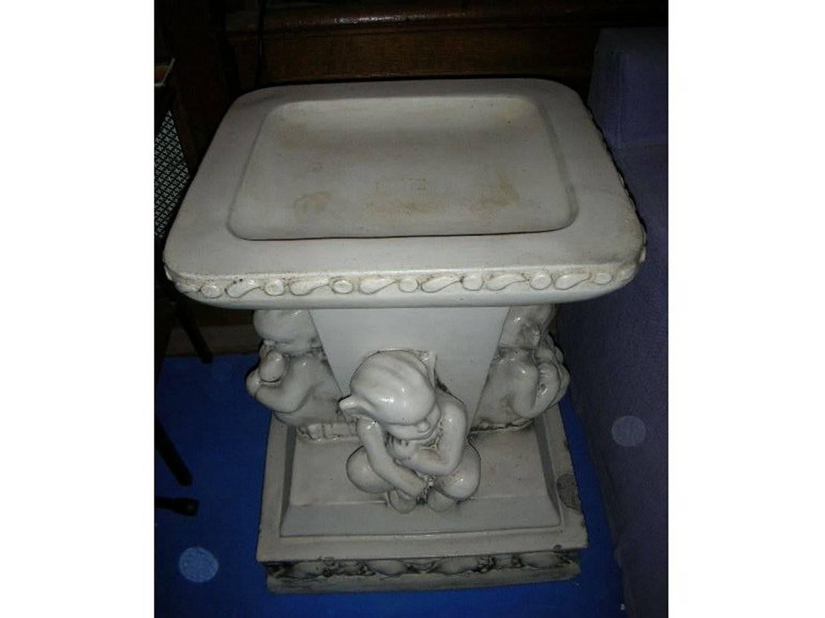 A rare and humorous stone ware bird bath with four little Elf like Leprechauns in various poses of thought and contemplation. Attributed to Leftco (Leeds Fireclay Co). Made in two parts, the top removes for easy movement. 
Some chips and nibbles