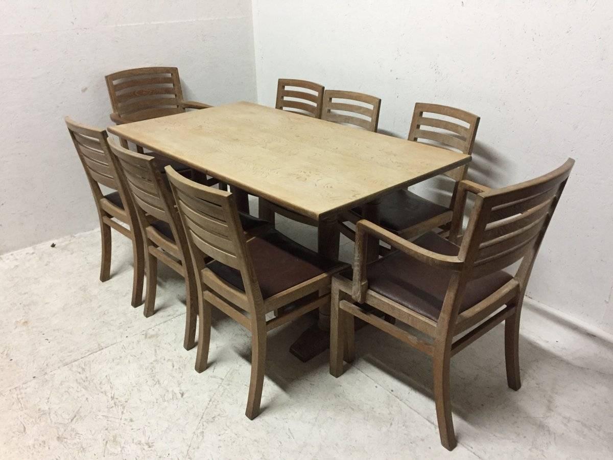 Heals. An Arts and Crafts limed oak dining set consisting of a Tilden dining table, six dining chairs and two armchairs (making eight in total) and a rare matching mirror. 
Dining table L 60