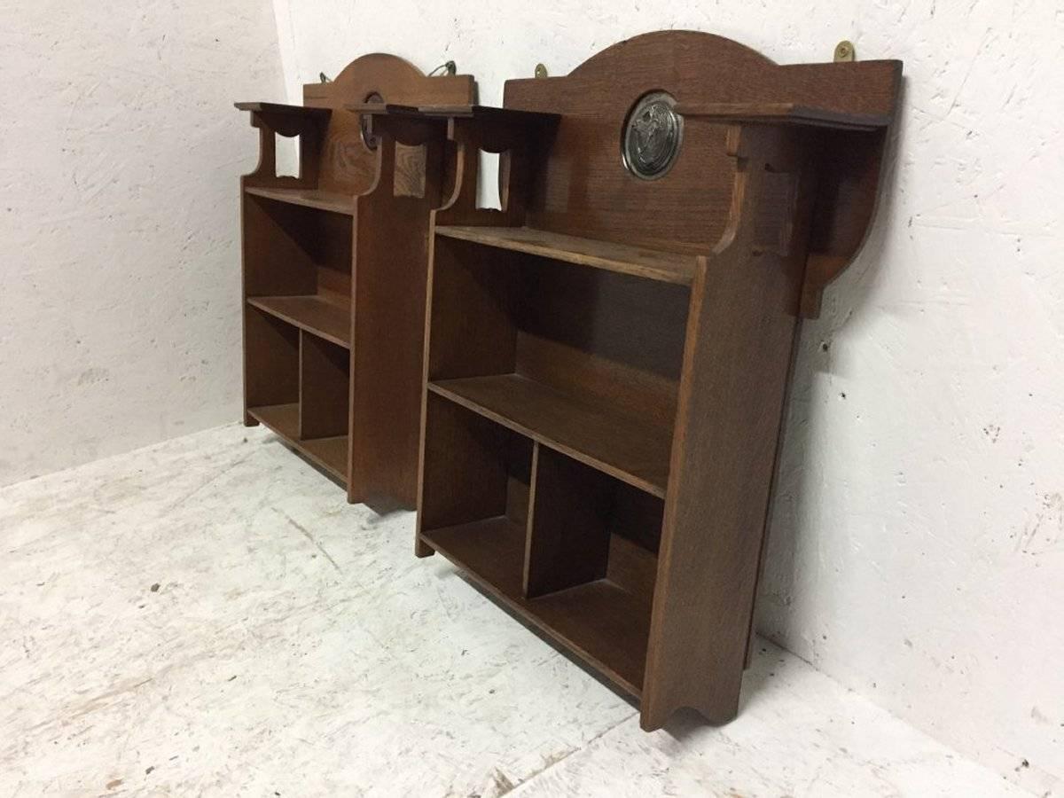 British Shapland and Petter, an Arts & Crafts Hanging Oak Bookcase with Copper Plaque For Sale
