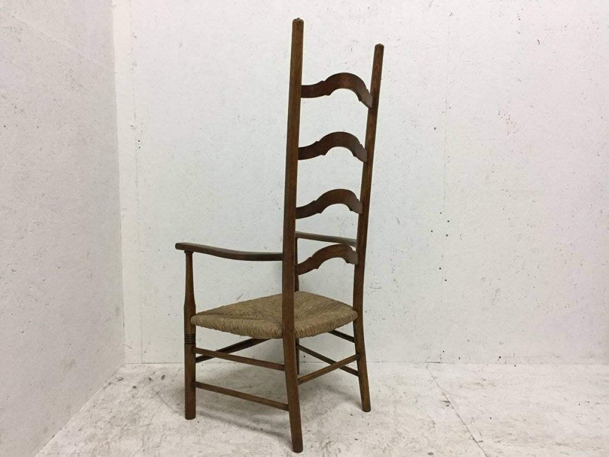 Liberty and Co., Arts and Crafts high back ladder back armchair with newly laid rush seat.