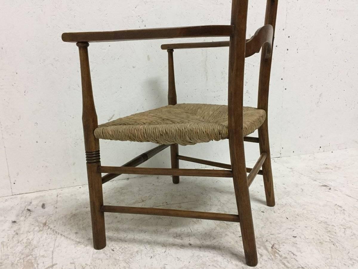 Arts and Crafts Liberty and Co., Arts & Crafts High Back Ladder Back Rush Seat Armchair For Sale