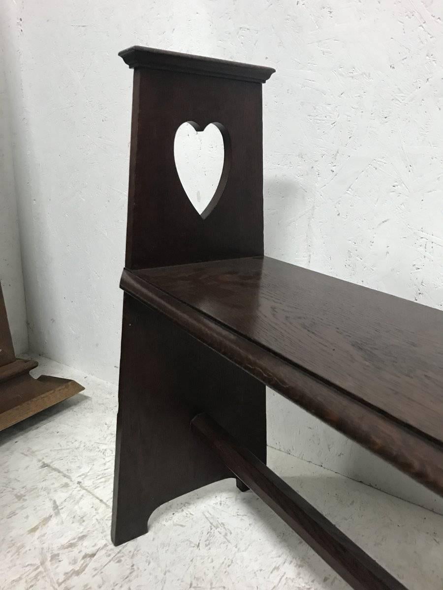 English Liberty & Co. An Arts & Crafts Oak Window or Hall Seat with Large Pierced Hearts For Sale