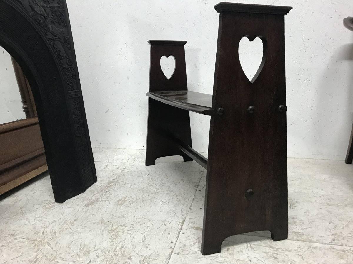 Arts and Crafts Liberty & Co. An Arts & Crafts Oak Window or Hall Seat with Large Pierced Hearts For Sale