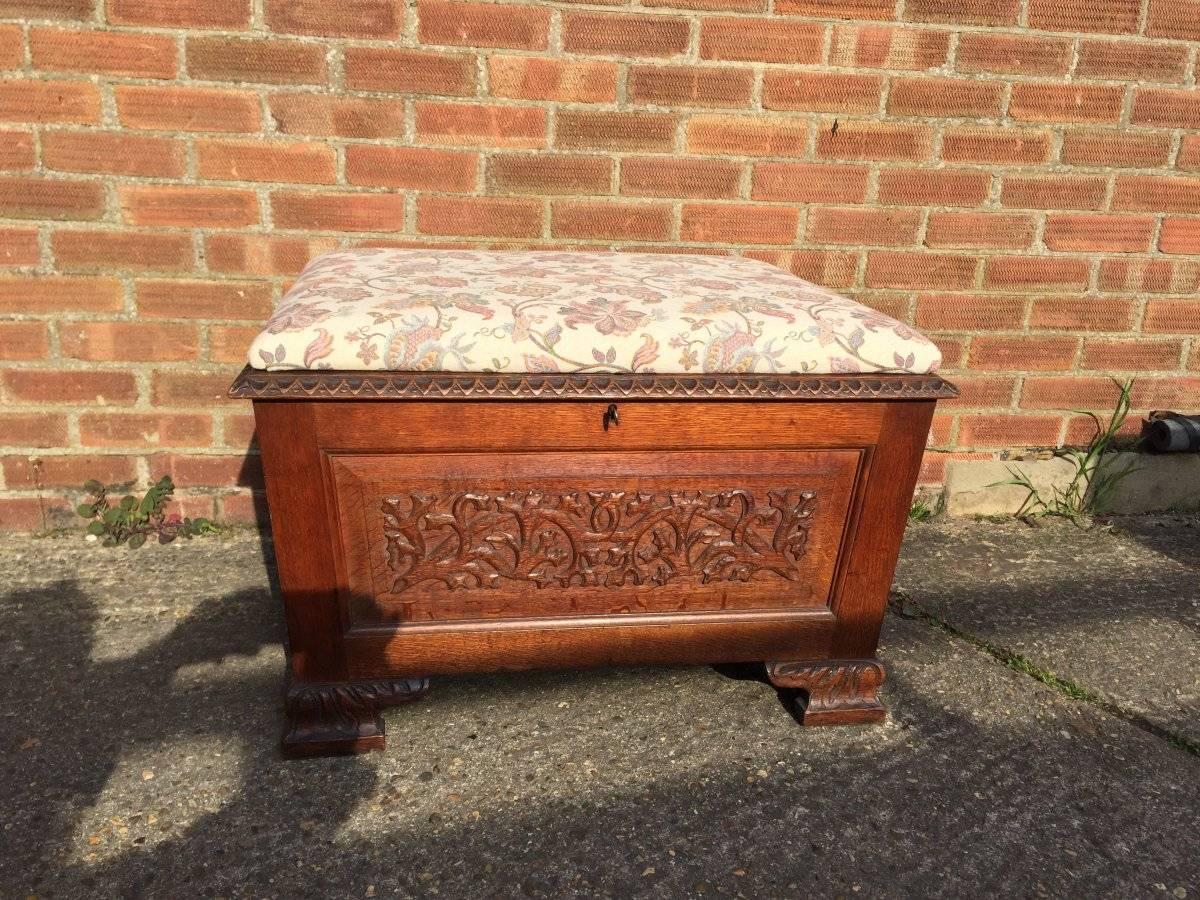 Arts and Crafts ottoman with all round carved floral decoration professionally re upholstered in a quality thick floral fabric with carved detail all around the upper edges and to the feet, the lift up lid opens to reveal good inside and lockable