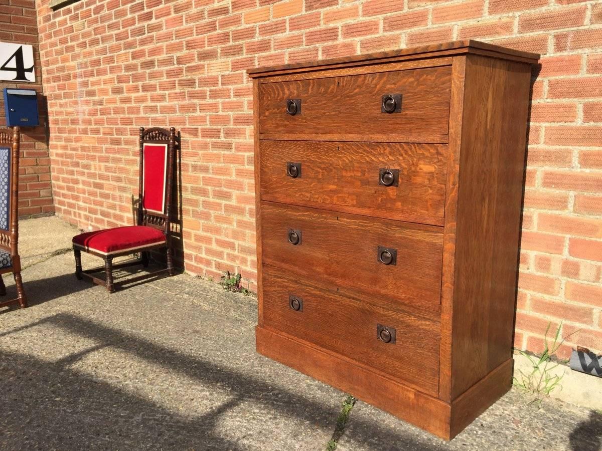 Heals attributed, A tall Arts & Crafts oak chest of drawers with hand-hammered steel back plates to the handles, and fine hand-cut dovetails to the drawers, very good craftsmanship..