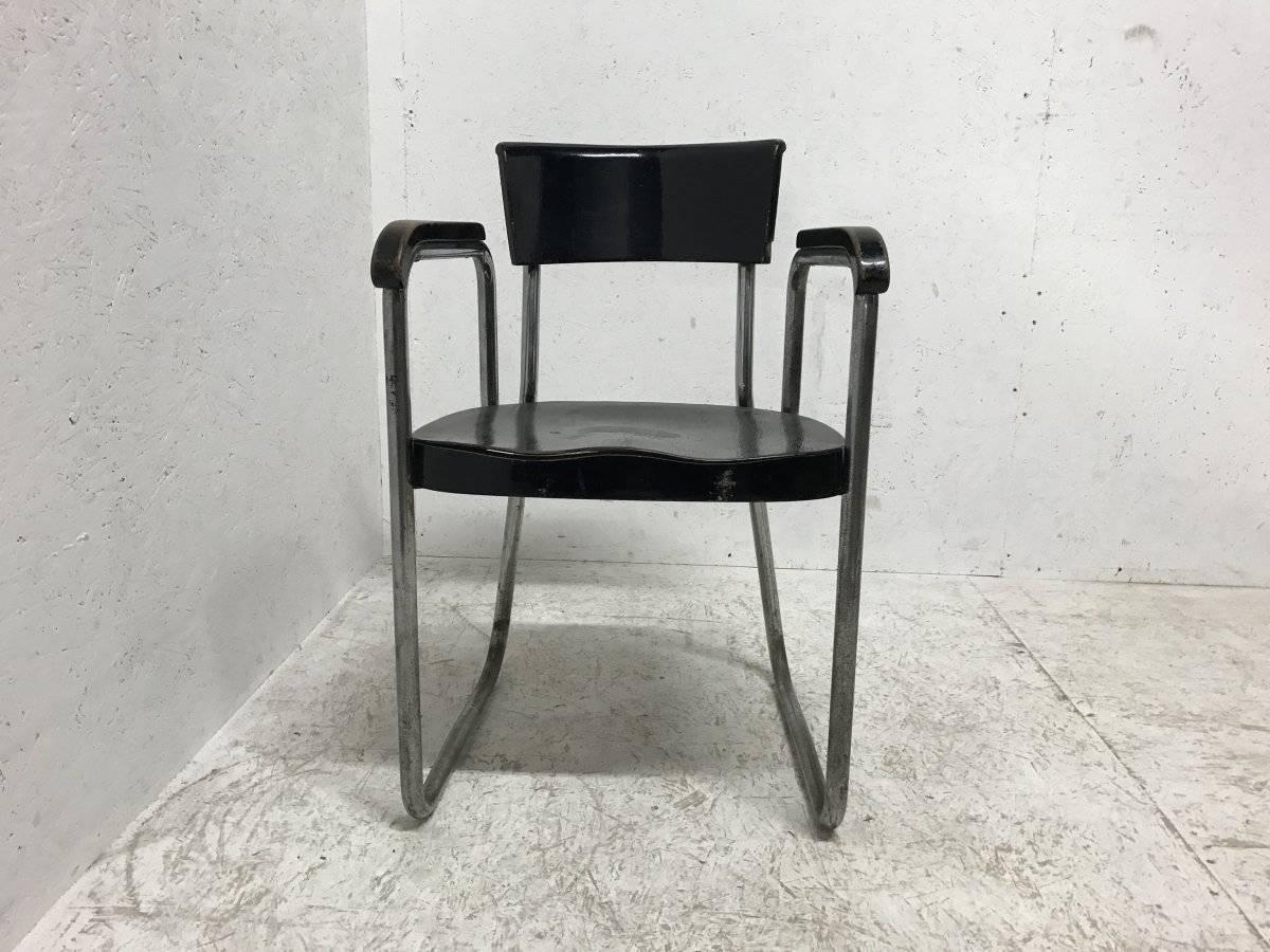 Emile Guillot tubular steel modernist armchair made by Thonet.
The shaped headrest, arms and shaped seat are ebonized Beech wood.
 