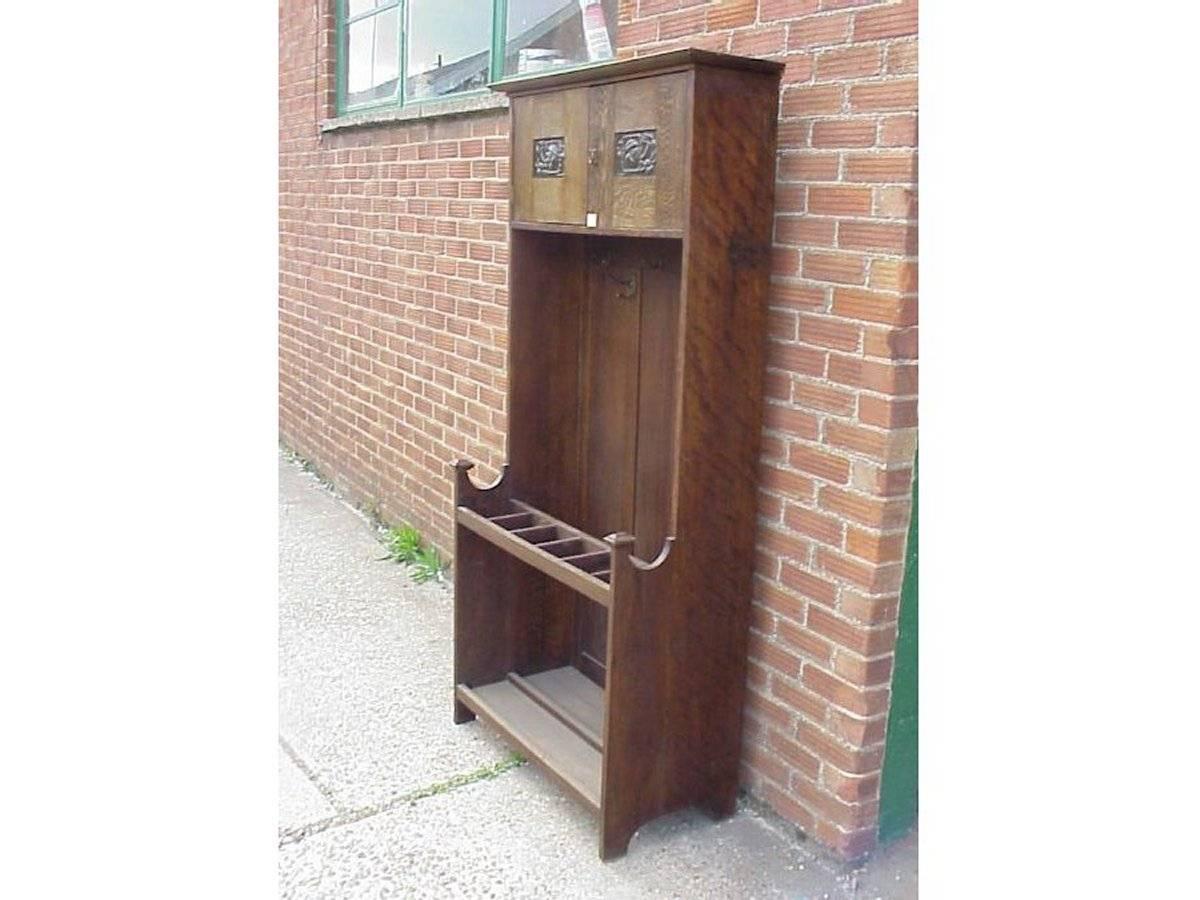 EA Taylor attributed, made by Wylie and Lochhead. An Arts and Crafts oak hall stand with stylised hand beaten copper panels to the upper cupboard doors. This hallstand is depicted in the Wylie and Lochhead catalogue of 1901, see last image.