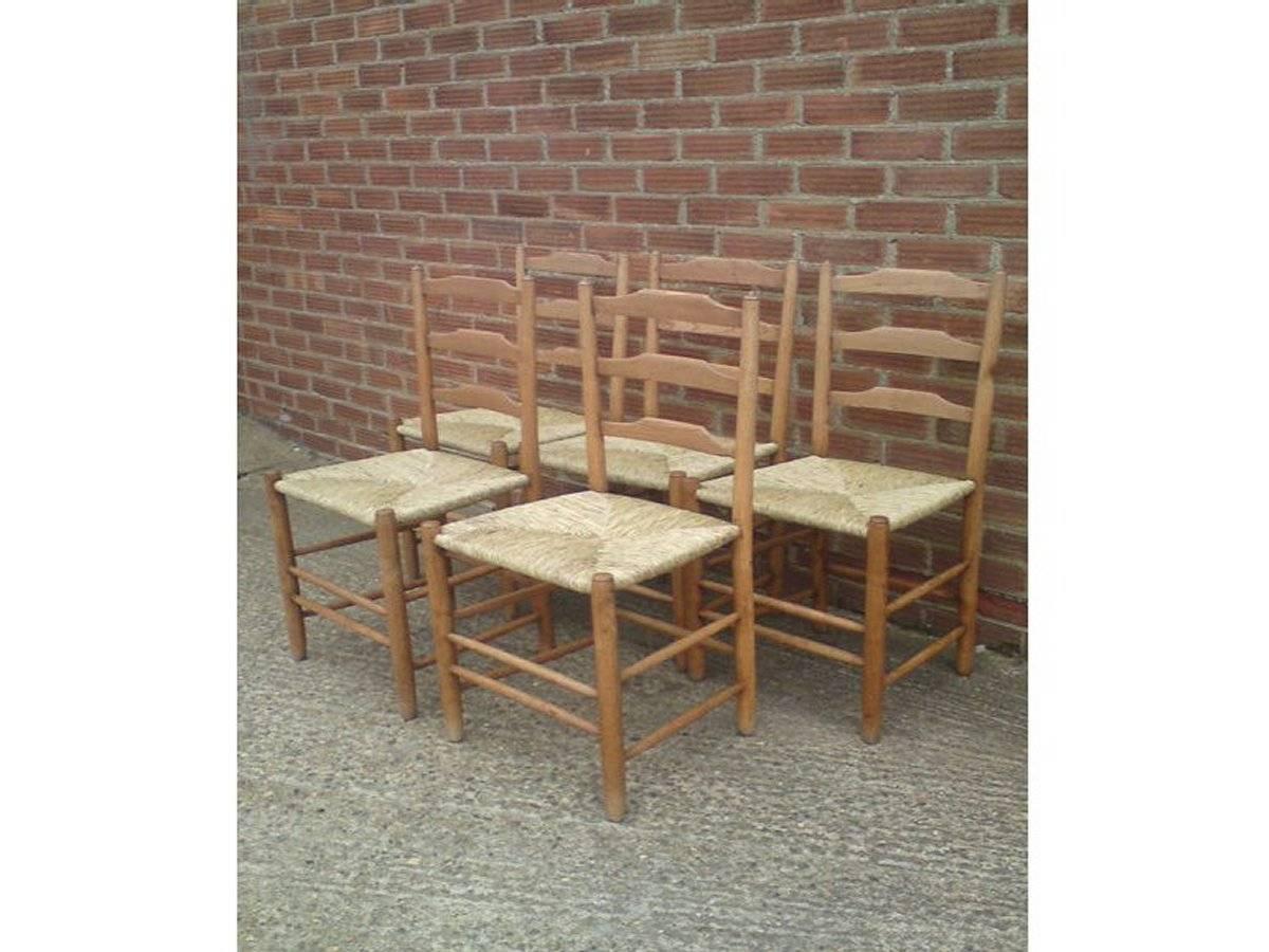Edward Gardiner. A set of five Arts and Crafts Cotswold School ladder back dining chairs, with newly laid rush seats.
These ladder back chairs are steeped in history, their design have evolved from a long line of English chair makers going back to