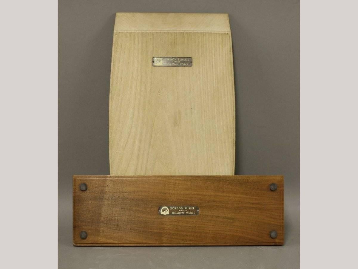 Gordon Russell. Broadway, Worcs. 
A cheese board made of ash: Length 15, width 9, height 2 inches
A pen tidy made of walnut: Length 14.5, width 4.5 inches, height 2 inches.