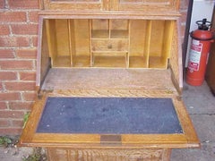 Heals. A Limed Oak Bureau Bookcase of Slim Proportions on Sledge Style Feet.