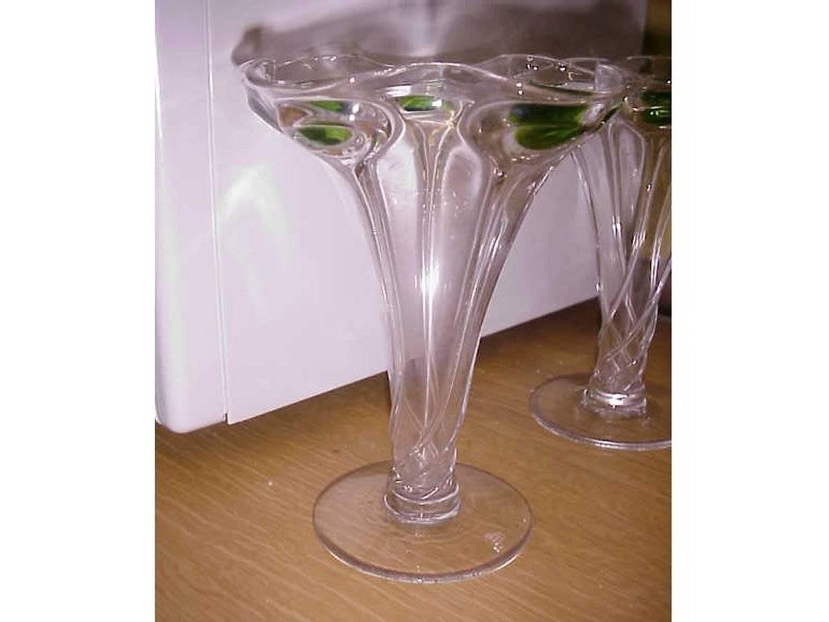 A pair of Arts & Crafts glass vases with swirl stems running up to the top centred with green ovals and wavy rim.