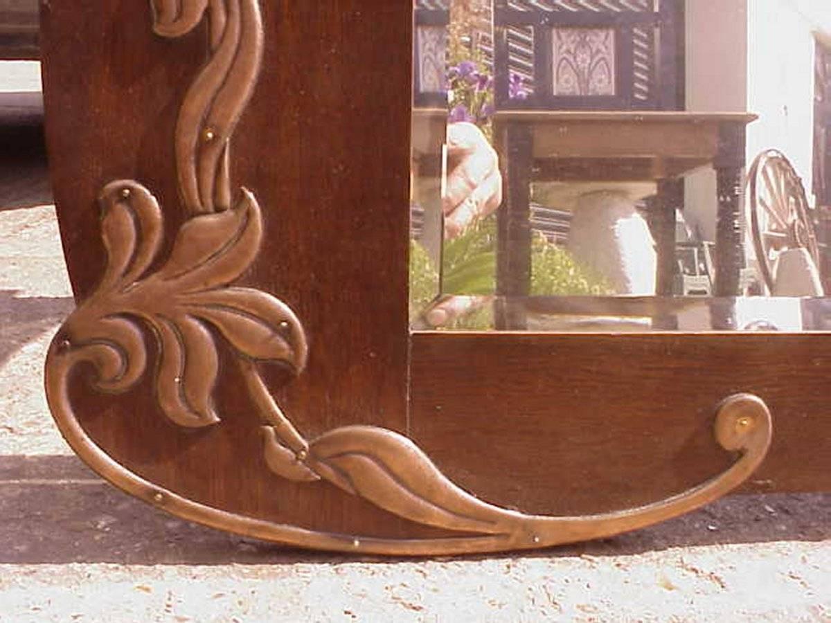 Hand-Crafted An Arts & Crafts Shaped Oak Bevelled Mirror with Stylised Floral Copper Details