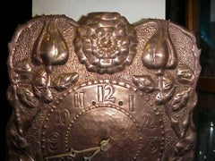 John Pearson Style of, an Arts & Crafts Copper Wall Clock with Repousse Flowers