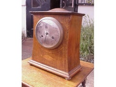 Liberty and Co Attributed. An Arts & Crafts Oak Mantle Clock with Chevron Inlays