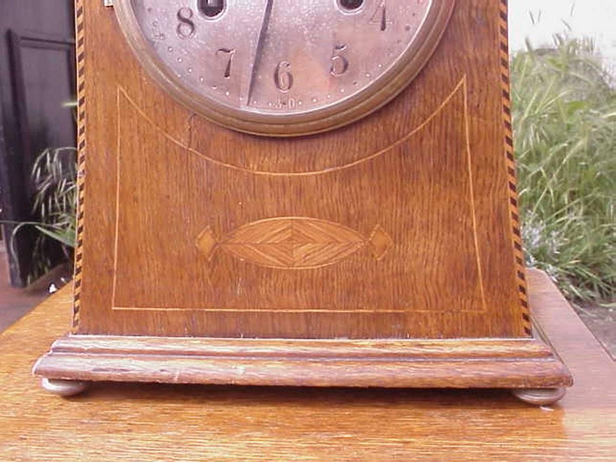 British Liberty and Co Attributed. An Arts & Crafts Oak Mantle Clock with Chevron Inlays
