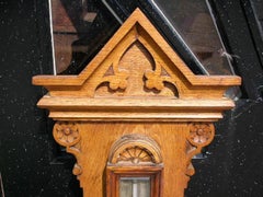 A Large Gothic Revival Carved Oak Barometer with a Rare Snail Tail Thermometer