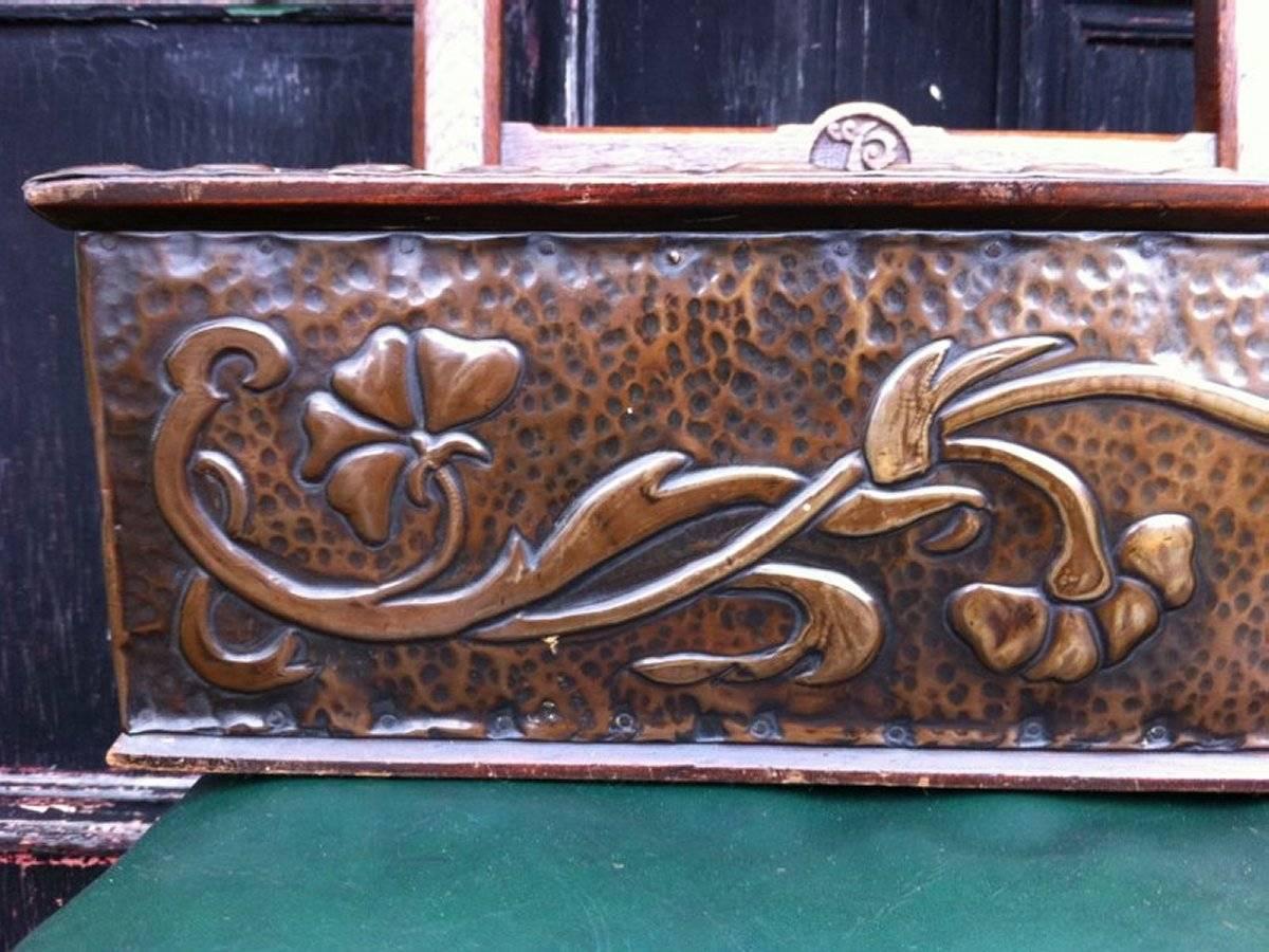 Liberty and Co, attributed, an Arts & Crafts desk top copper bookcase with stylised floral details and nice chocolate patina.