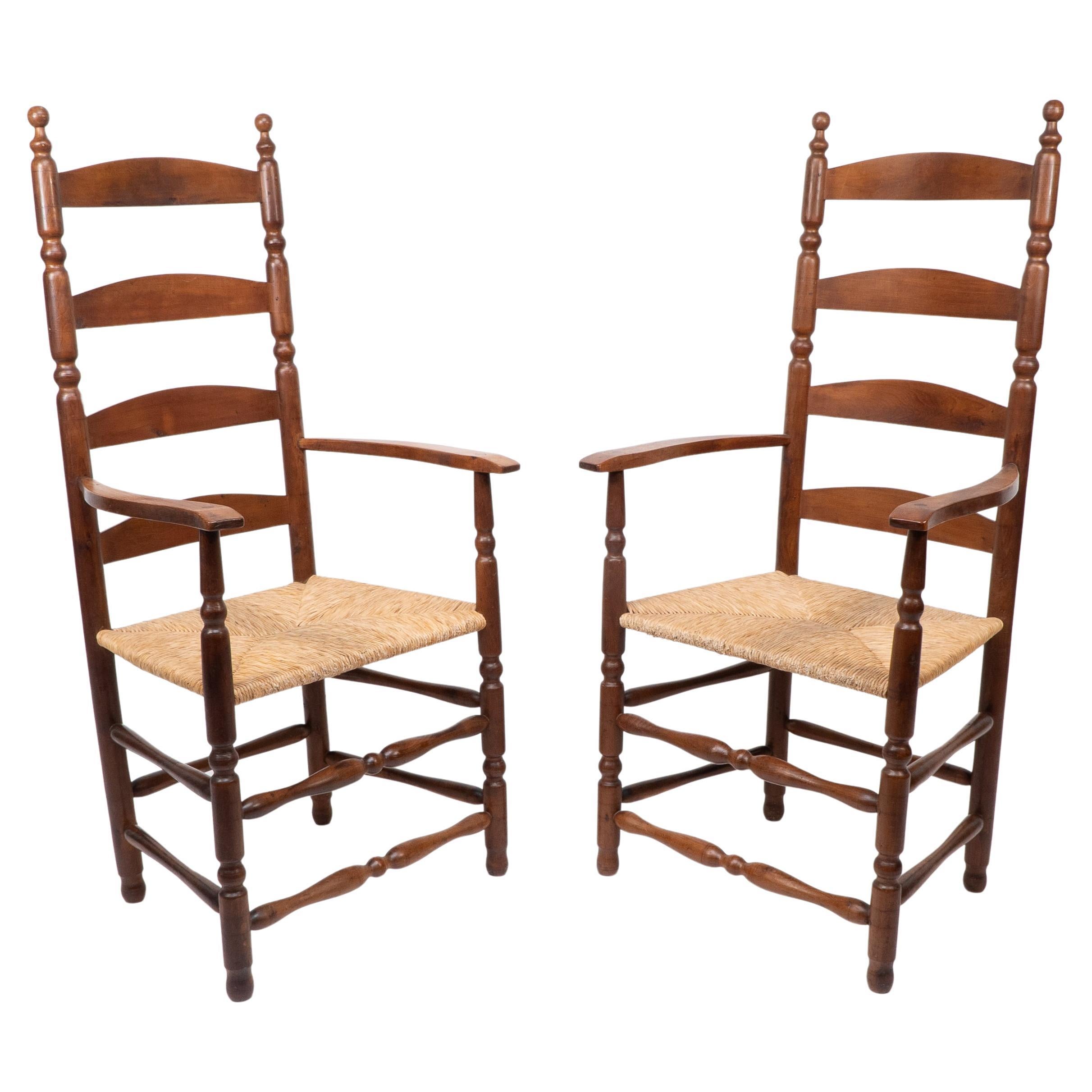 Ernest Gimson. A pair of yew wood ladder back and bobbin turned armchairs