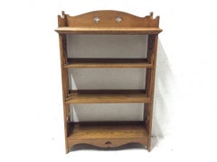 Liberty & Co Attributed, an Arts & Crafts Oak Bookcase with floral cut-outs