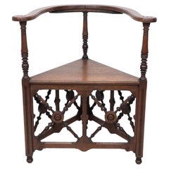Antique Jas Shoolbred, an Aesthetic Movement Oak Corner Armchair with Stylized Turnings
