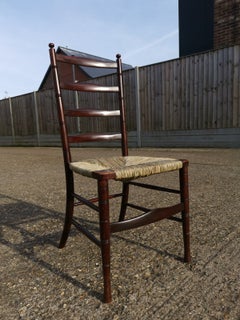 Antique Liberty & Co. An English Aesthetic Movement Walnut Ladder Back Rush Seat Chair
