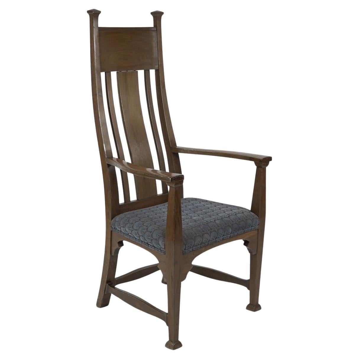 Norman & Stacey (attributed). An Arts and Crafts walnut high back armchair