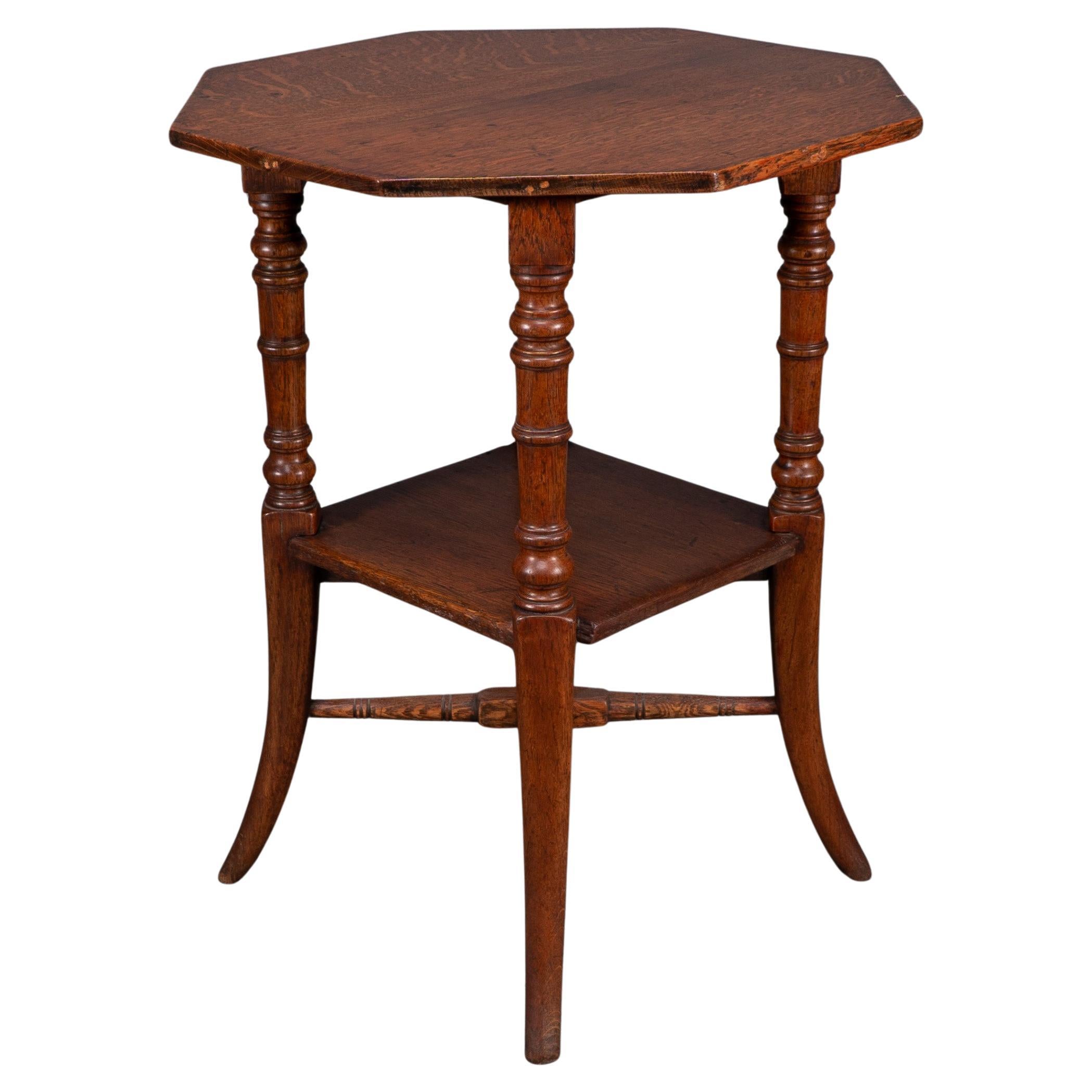 Jas Shoolbred and Co (attributed) An octagonal oak side table with central shelf