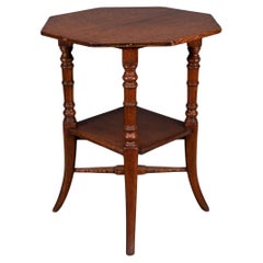 Jas Shoolbred and Co (attributed) An octagonal oak side table with central shelf