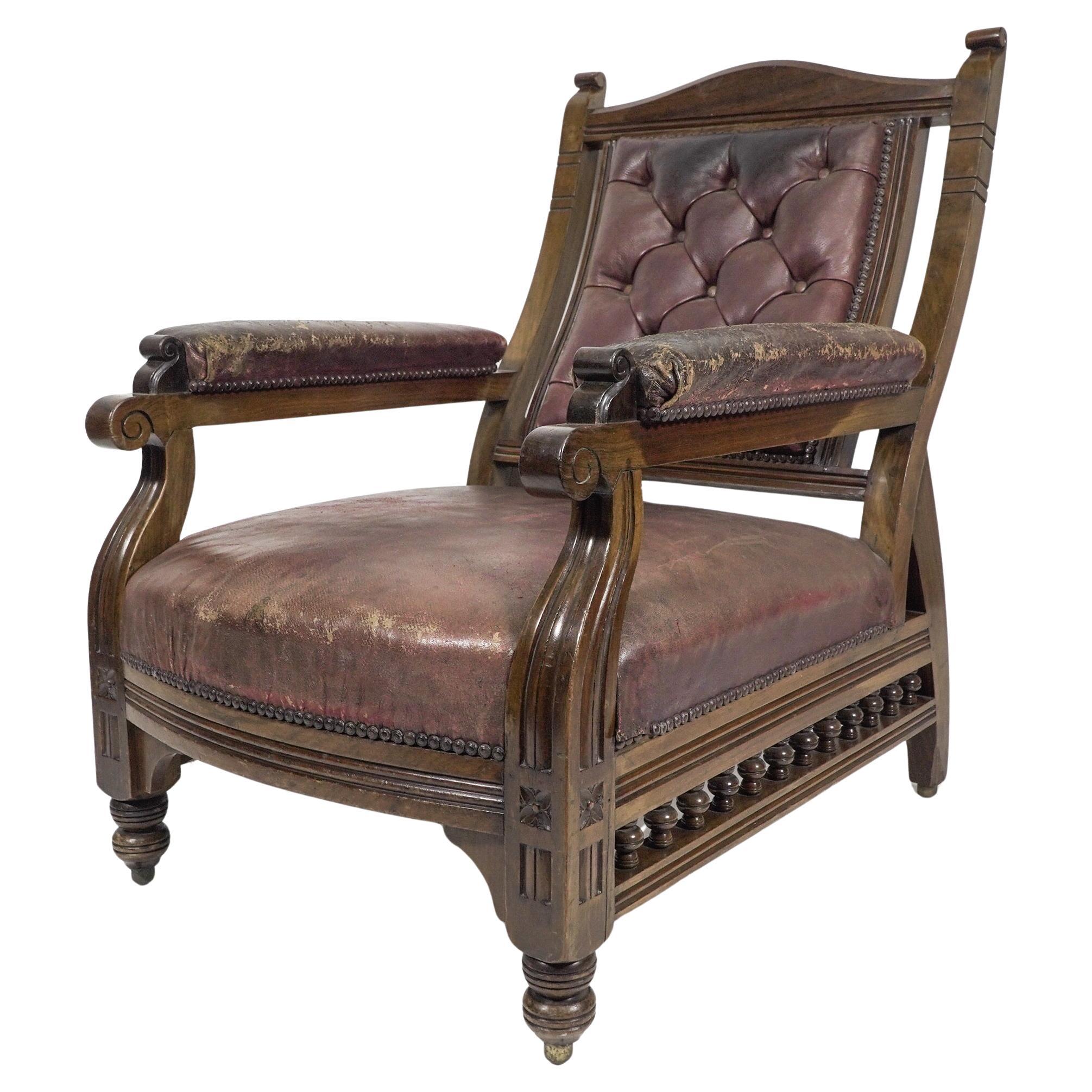 An Aesthetic Movement walnut armchair with a curvaceous back leather upholstery. For Sale