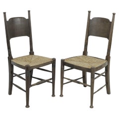 Used William Birch, retailed by Liberty & Co. Pair of Arts & Crafts oak dining chairs