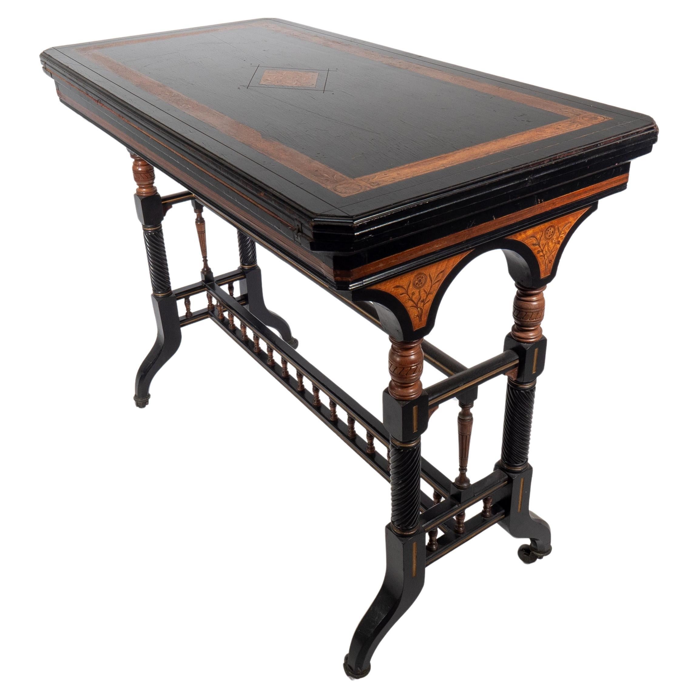 Gillows attr An Aesthetic Movement ebonized & fold over floral inlaid card table