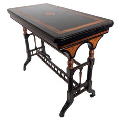 Antique Gillows attr An Aesthetic Movement ebonized & fold over floral inlaid card table