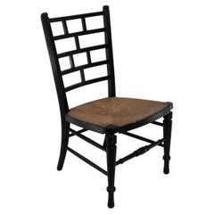E W Godwin (style of). An Anglo-Japanese rush seat ebonized side chair