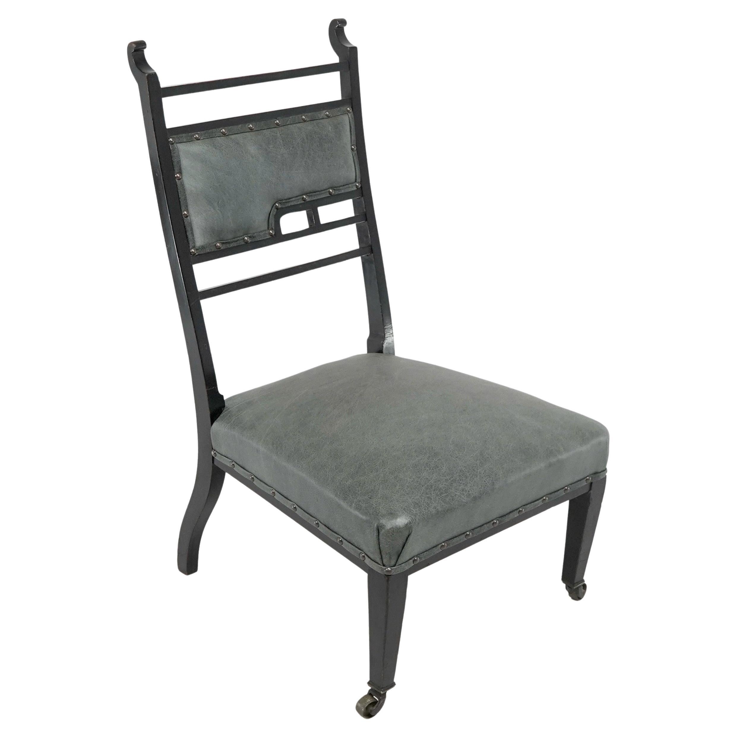 An Anglo-Japanese ebonized side or nursing chair with green hide upholstery For Sale