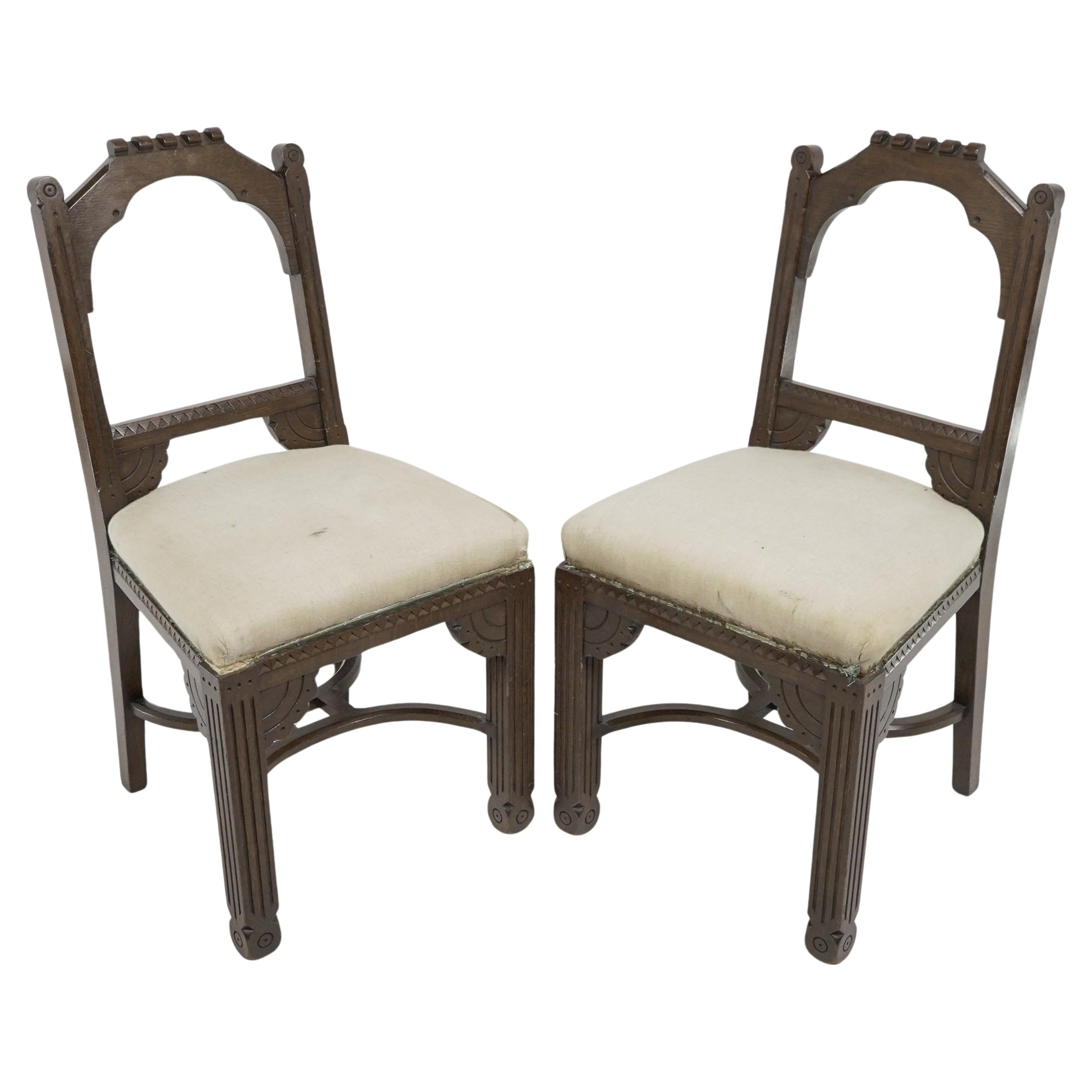 R Boyd. in the style of Dr C Dresser. A pair of oak side chairs