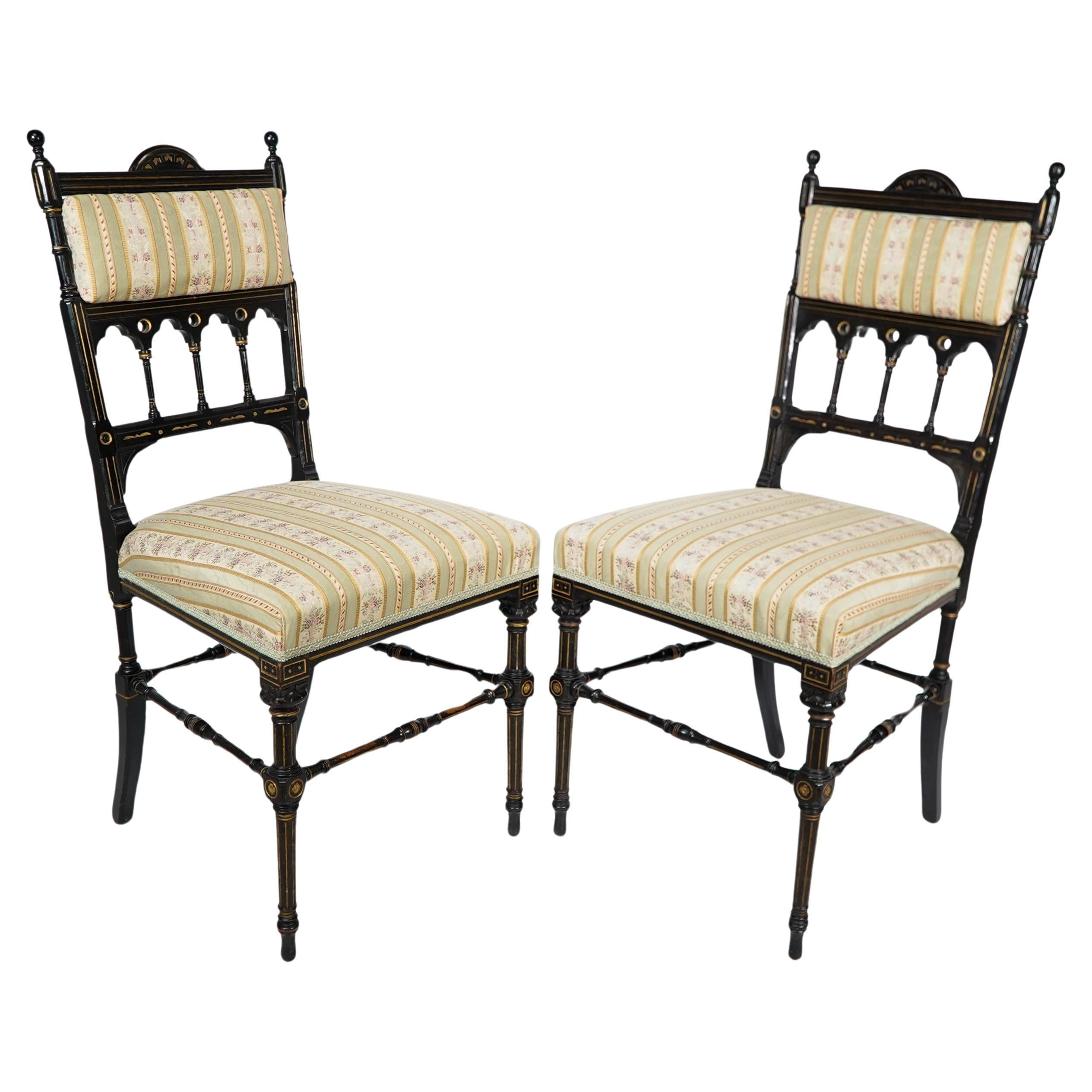 Whytock & Reid. A pair of Aesthetic Movement ebonized & parcel gilt side chairs.