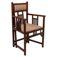 Antique Bombay Art Furniture An Anglo-Japanese Walnut armchair with a double back leg.