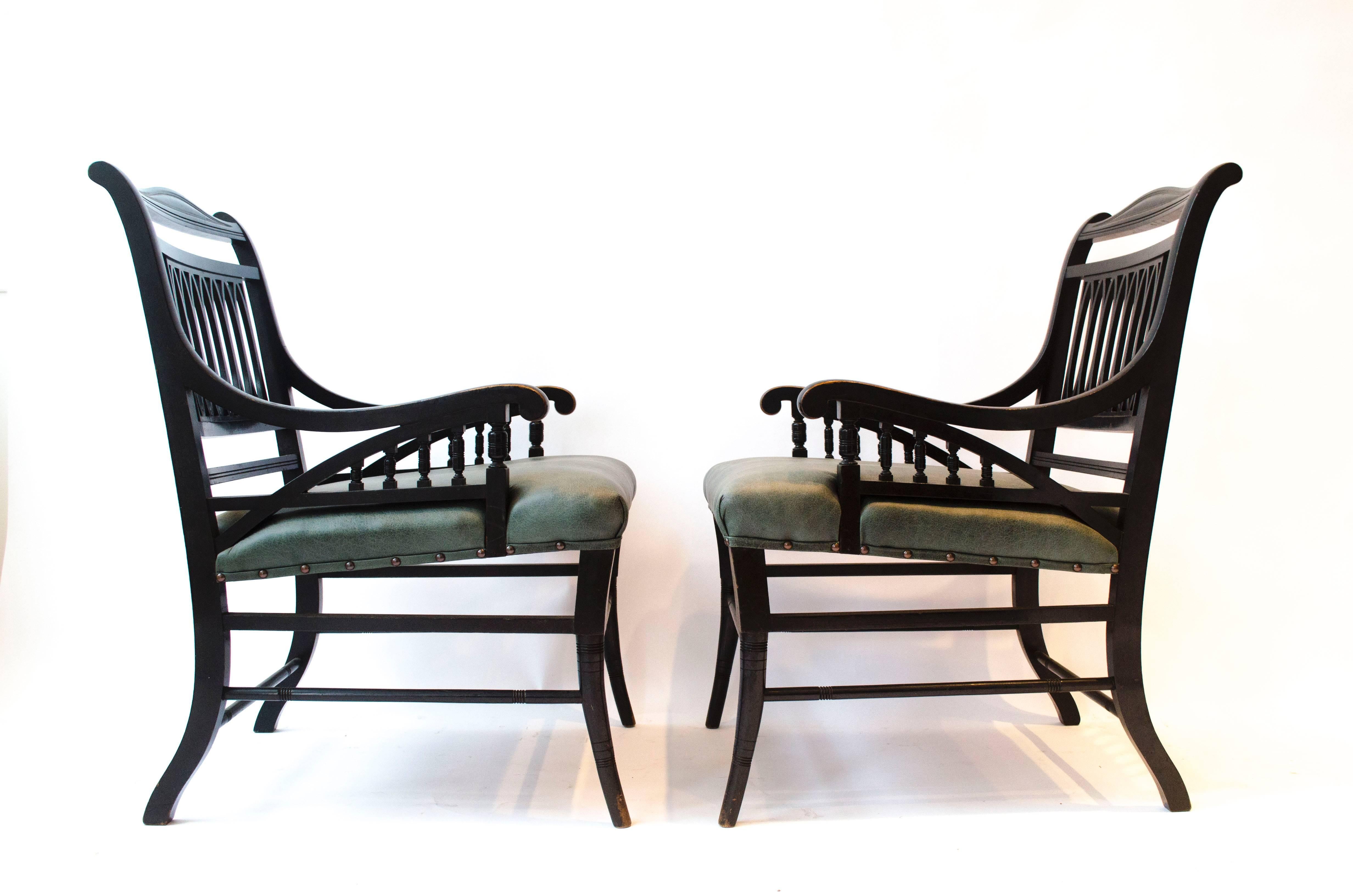 English Pair of Anglo-Japanese Ebonized Open Armchairs. Attributed to Jas Shoolbred For Sale