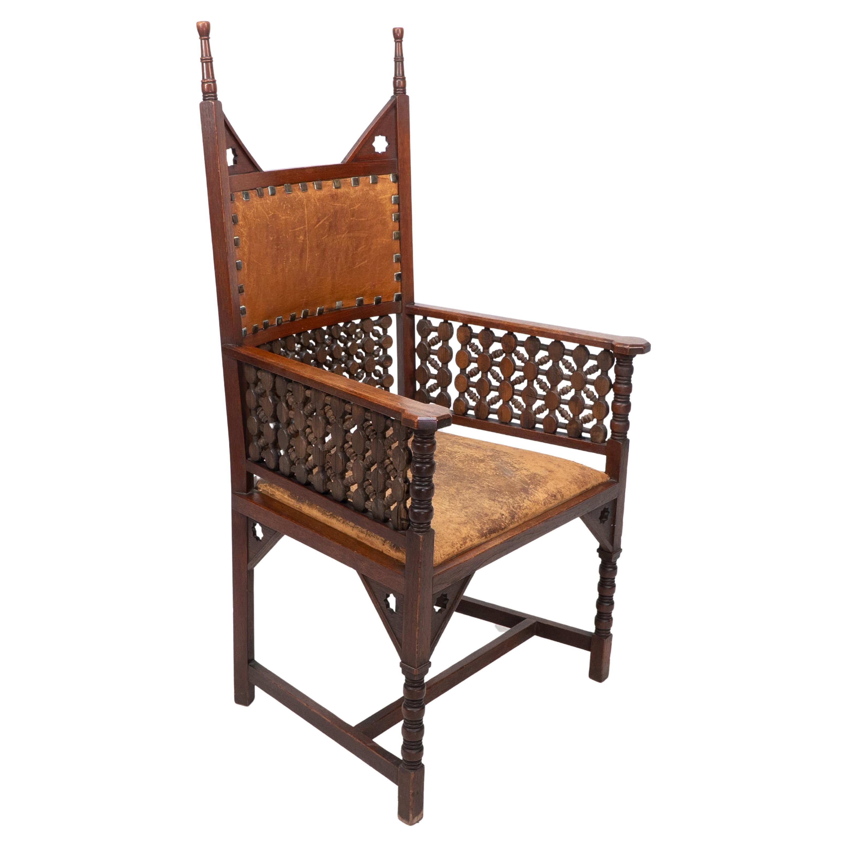 Liberty & Co. A Moorish Arts & Crafts walnut armchair with original leather seat For Sale