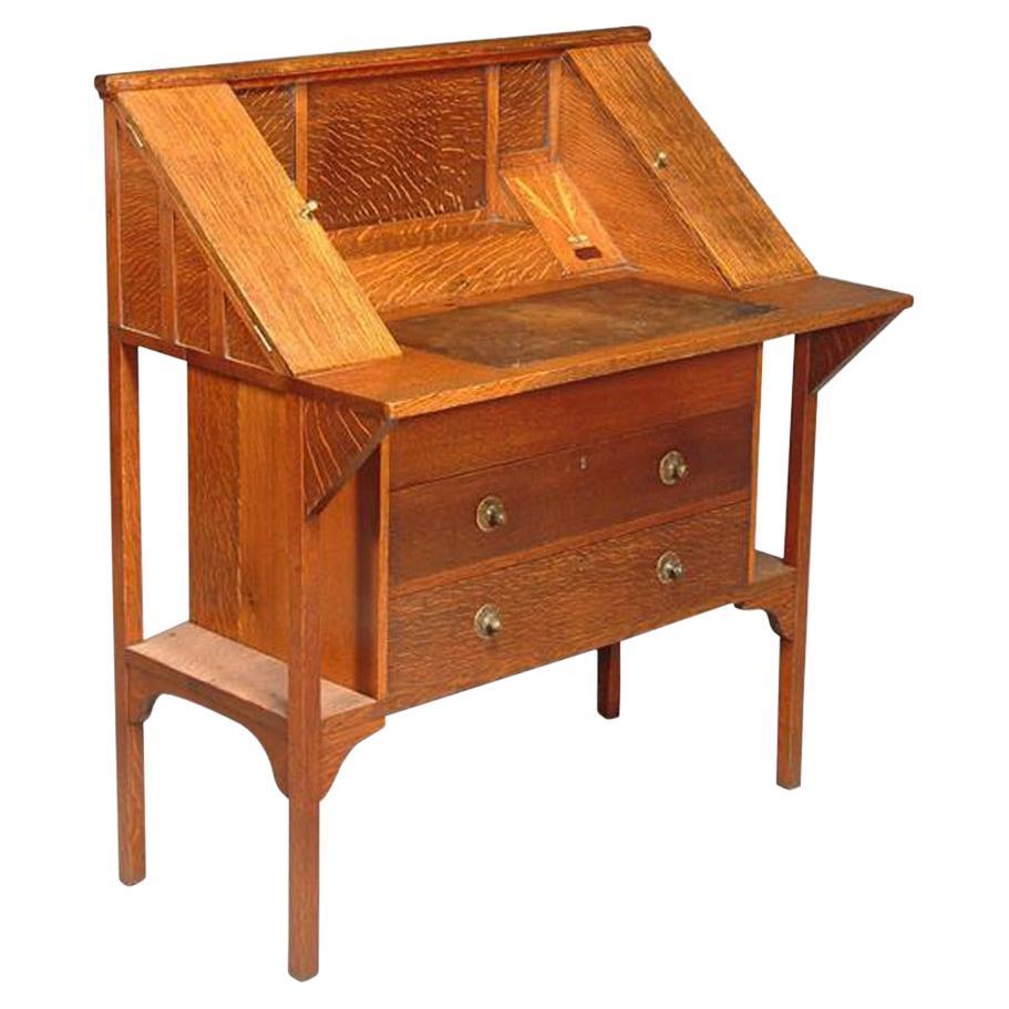 G M Ellwood for J S Henry. An Arts & Crafts oak writing desk For Sale