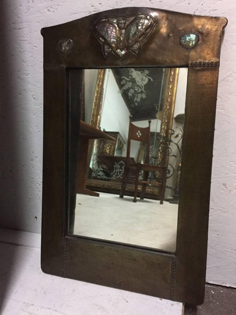 A superb Arts and Crafts mirror by Liberty and Co.
Has had a small repair at some point a long time ago which you can just make out in the images, it is to the left hand lower corner of the actual mirror.