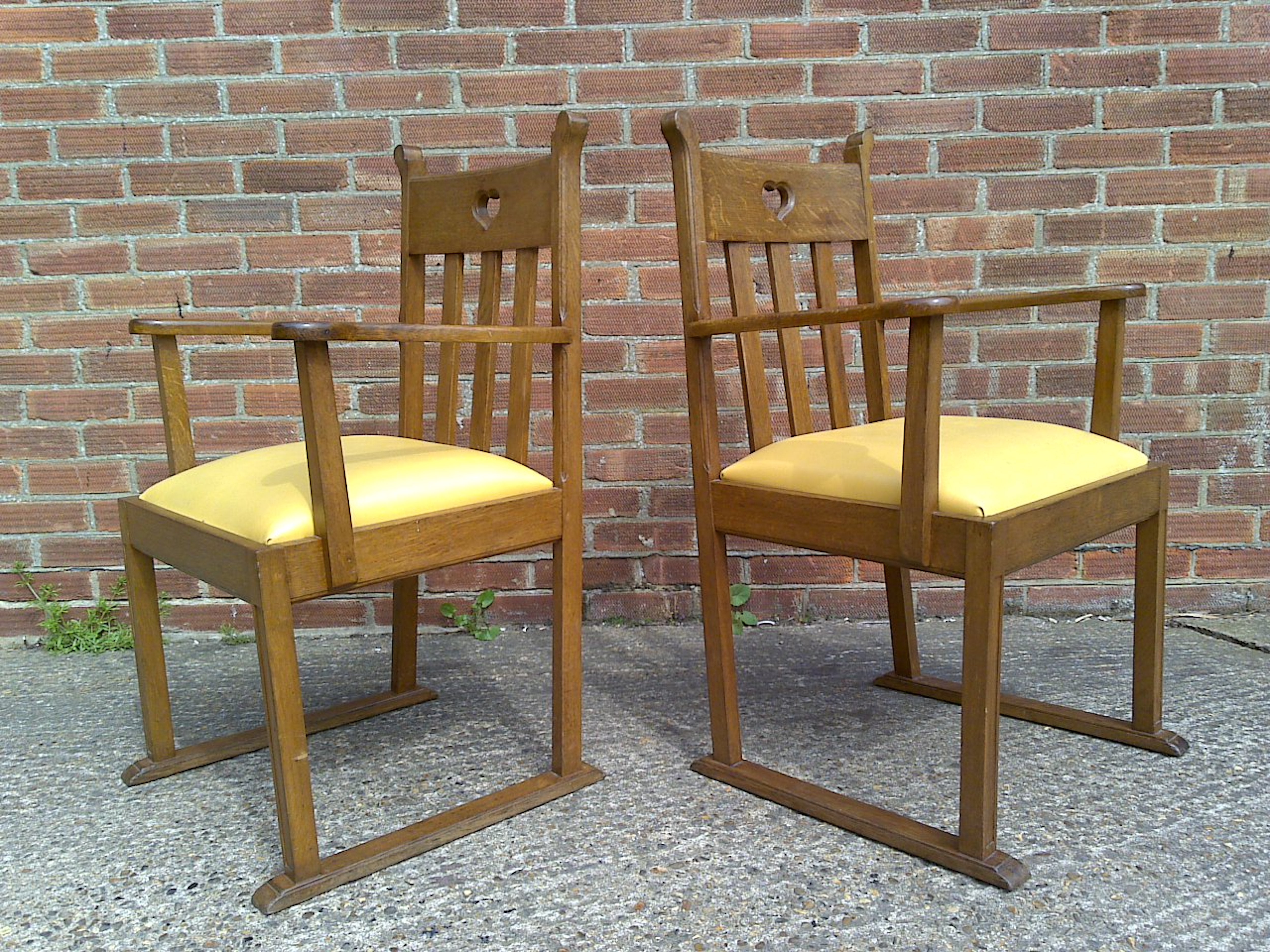 Pair Oak Armchairs, in the style of Liberty & Co with heart Cut-Out to the backs For Sale