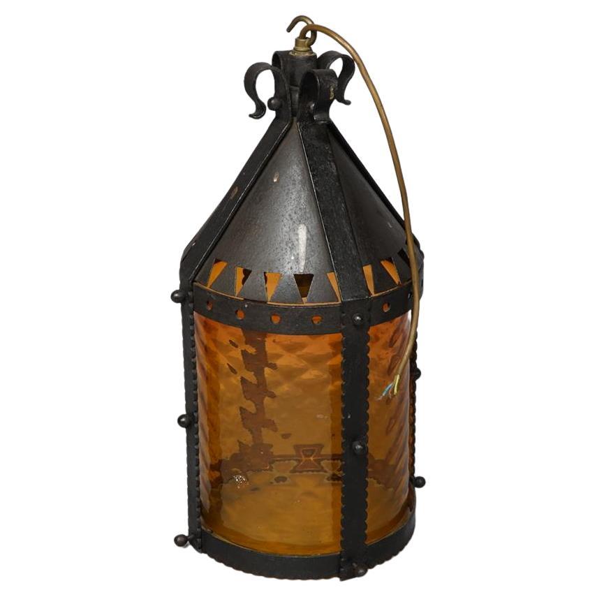 A large Arts and Crafts iron lantern retaining the original dappled amber shade.

 