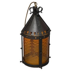 A Large Arts and Crafts Iron Lantern Retaining the Original Dappled Amber Shade.