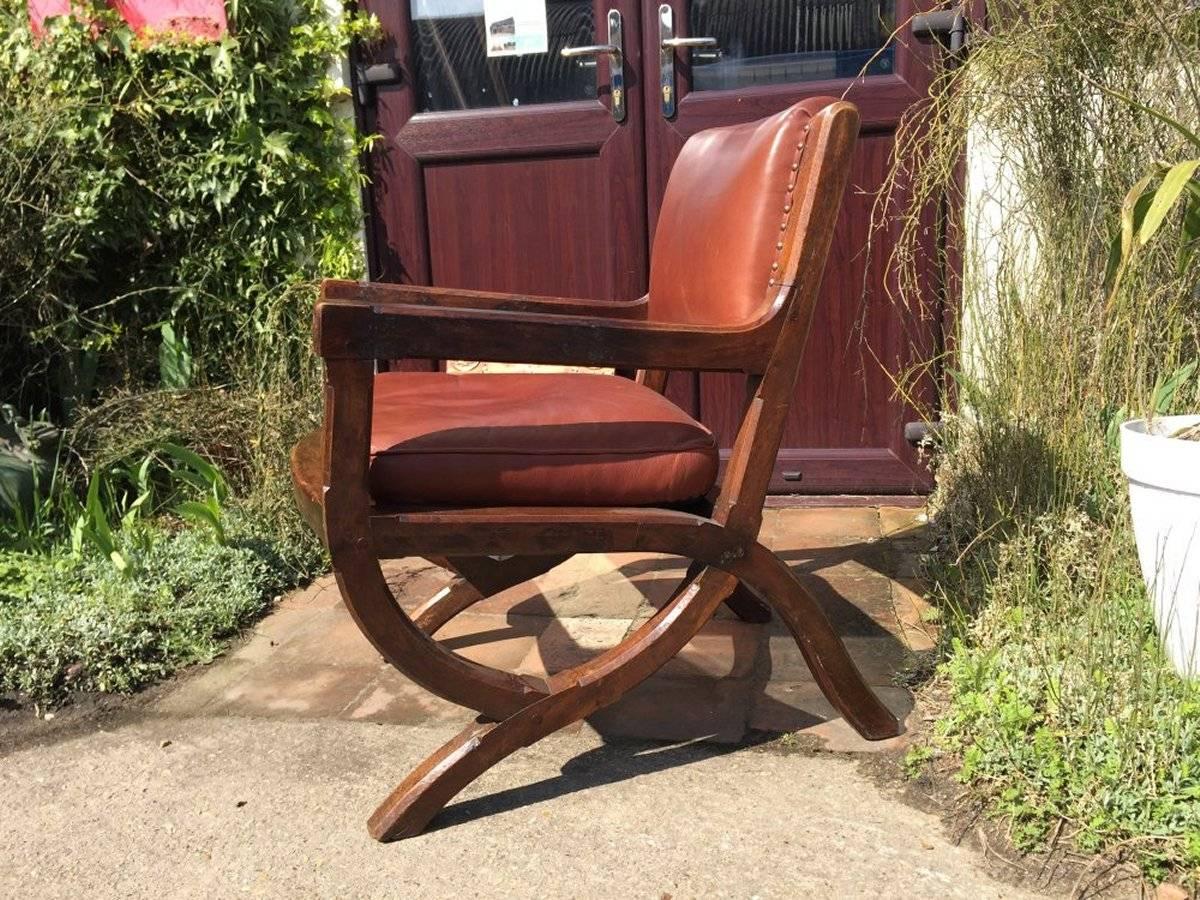 A super quality Arts and Crafts oak armchair in style of E W Pugin with a subtle architectural Gothic Revival organic styling and exposed peg construction retaining its original patina. The brown leather is nicely worn in and also in great