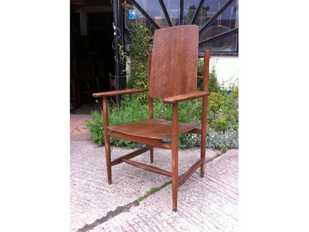 A Scandinavian style designer armchair. It is a well designed oak and teak armchair with nice wide yet sculptured arms and beautifully made detailing supporting the back, with exposed through tenon details to the squashed oval style supports and